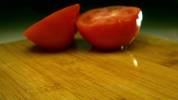 Tomato Halves Fall On Wooden Cutting Board. Super   Video