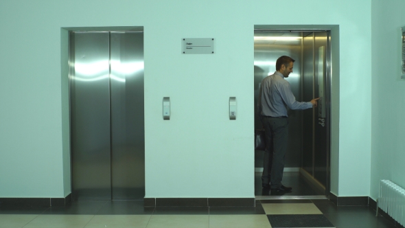 Young Businessman Waiting For Elevator