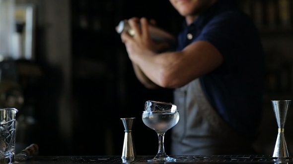 Hands Of The Barman Shake An Alcoholic Cocktail