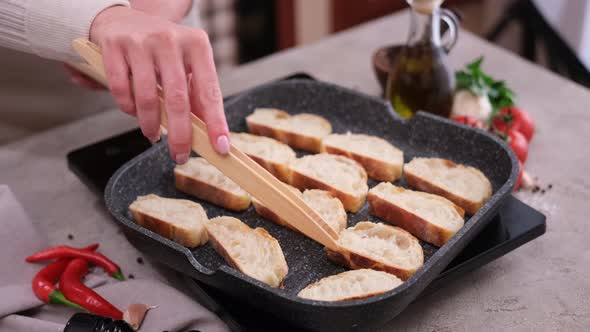 Toasting Slices of Baguette in a Grill Frying Pan