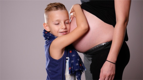 Boy Kissing The Belly of His Mother