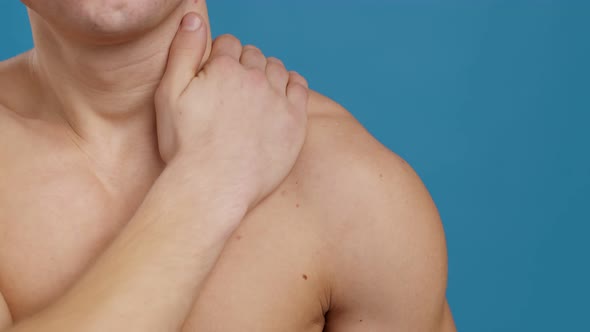 Unrecognizable Muscular Guy Massaging His Painful Delta Muscles After Hard Workout Close Up Shot