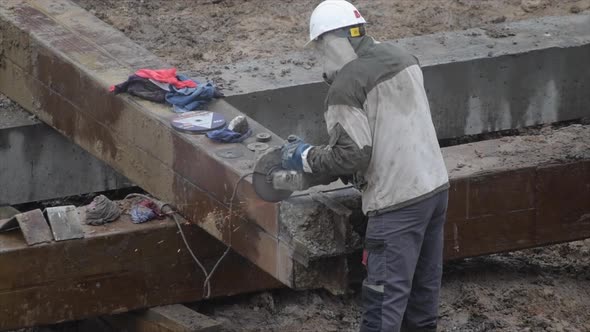 Angular Saw Grinding Through Construction Piles at Construction Site