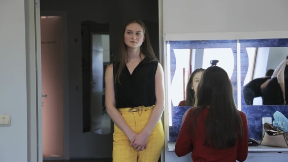 Beautiful Girl In Yellow Trousers Stands In Dressing Room