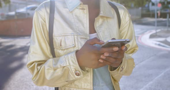 Woman using mobile phone in city street 4k