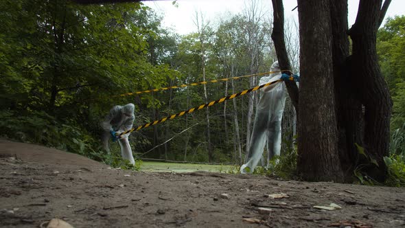 People Wearing Ppe White Suits Protecting Territory with Signal Tape