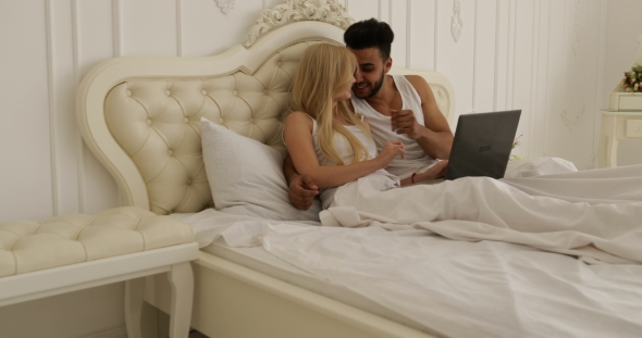Couple Lying Bed Using Laptop Computer, Mix Race Man Woman Smile Morning Bedroom
