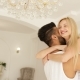 Young Happy Couple Embrace Woman Run And Jump Over Man Hug Spin Around Modern Home Bedroom Circling - VideoHive Item for Sale