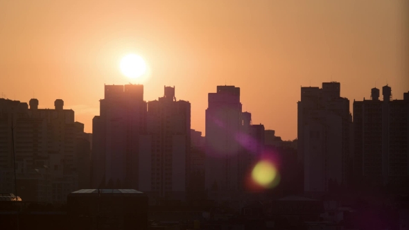 Sun Rising and Moving in the Sky, City Modern Buildings on the Foreground. Seoul, South