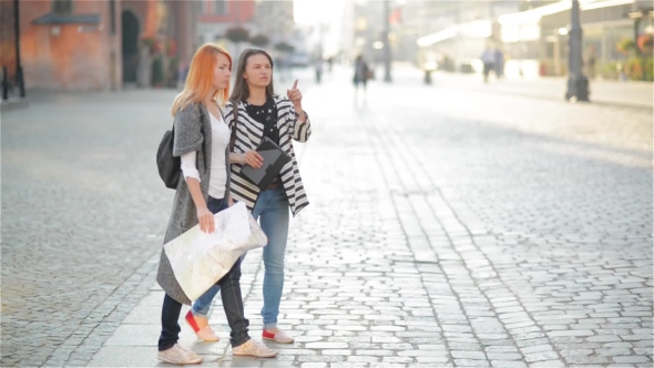 Two Young Girls on the Streets of the Old City. Girlfriends Try to Find Their Way in an Unfamiliar