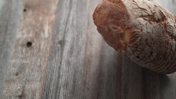 Sliced sourdough bread falling on a table. Slow Motion.