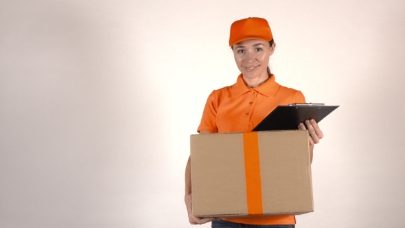 Girl Courier In Orange Uniform Delivering a Big Carton. Light Gray Backround,  Studio Shot