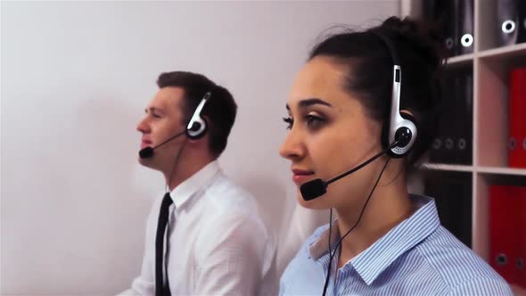 Attractive Sexy Female Employee in Headset Calling to Client