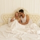 Couple Lying Bed Using Tablet Computer, Mix Race Man Woman Smile Morning Bedroom - VideoHive Item for Sale