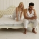 Couple Lying Bed Using Smart Phone Mix Race Man Woman Having Fun Playing Embrace Smile Morning - VideoHive Item for Sale