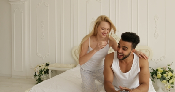 Couple Lying Bed Using Smart Phone Mix Race Man Woman Having Fun Playing Embrace Smile Morning
