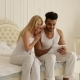 Couple Sitting Bed Using Tablet Computer, Mix Race Man Woman Smile Morning Bedroom - VideoHive Item for Sale