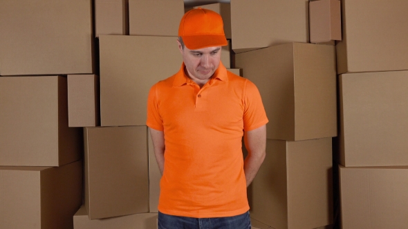 Courier In Orange Uniform Delivering Damaged Parcel To Customer. Brown Cartons Background. Flaw And