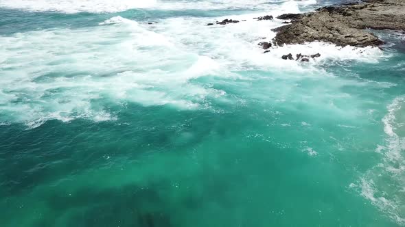 Waves crashing over rocks at Barrigona Beach aka Mel Gibsons beach in Costa Rica