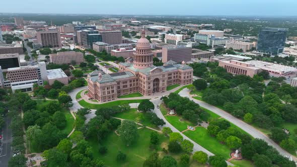 Wide aerial orbit of Texas State Capitol building in Austin, capital of TX. City panorama in beautif