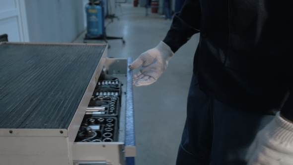 Mechanic Open Blue Metal Box With Different Tools For Car Repair At Modern Service Station