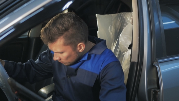 Professional Car Mechanic Working In Modern Auto Repair Service And Checking Engine alt