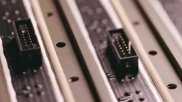 Slider Shot of a Connectors Component and Large Green Microcircuit in Workshop Laboratory