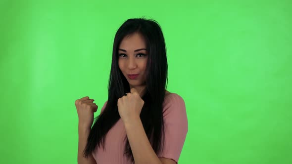 Young Attractive Asian Woman Does Martial Poses - Green Screen Studio