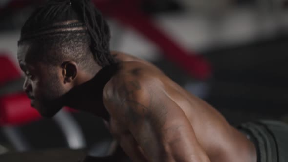 Side View Strong Muscular African American Motivated Sportsman Doing Pushups Indoors in Gym