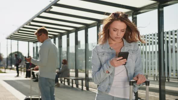 A Young Woman is Texting on Her Smartphone