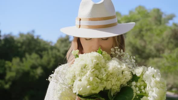 Closeup Portrait of Beautiful Smiling Woman Smelling White Flowers Bouquet RED