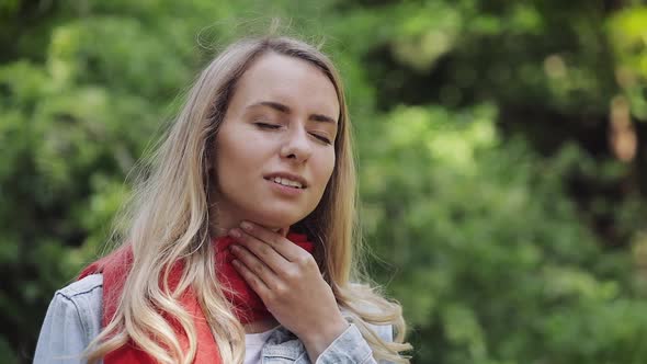 Sick Young Woman Wearing Red Scarf Feeling Bad Suffering From Throat Pain, Sore Throat, Standing in