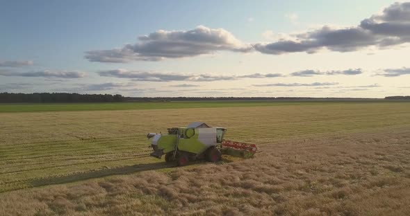 Upper View Combine Drives and Puts Down Platform in Field