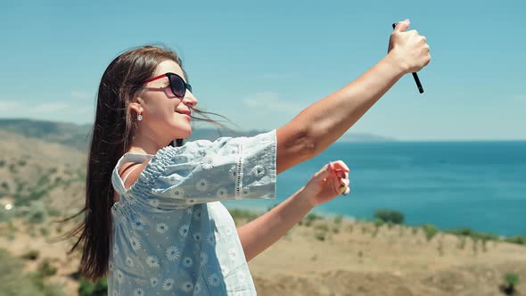 Portrait of Elegant European Traveler Woman Taking Selfie Using Smartphone