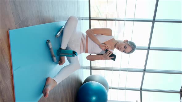 Young Sporty Girl Showing Exercises Online Using Smartphone