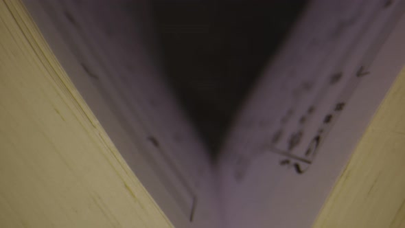 Macro Shot Through Musical Notes Inside of Book As It Opens