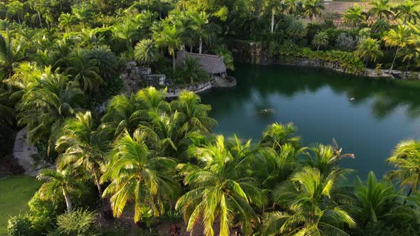 Aerial view of a tiki next to a lake on a sunny and beautiful afternoon in South Florida