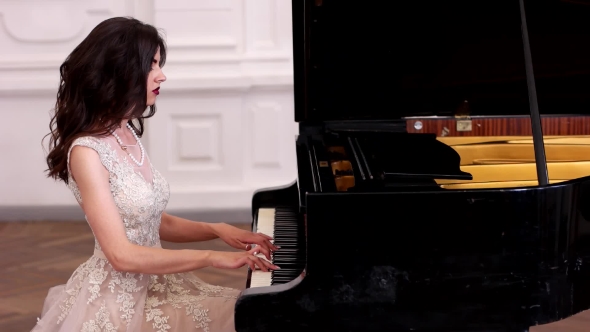Beautiful Girl Musician Plays The Piano