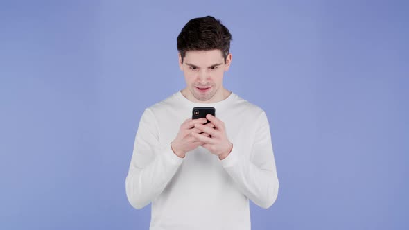 Handsome Man Receives Happy Notification on Mobile Phone