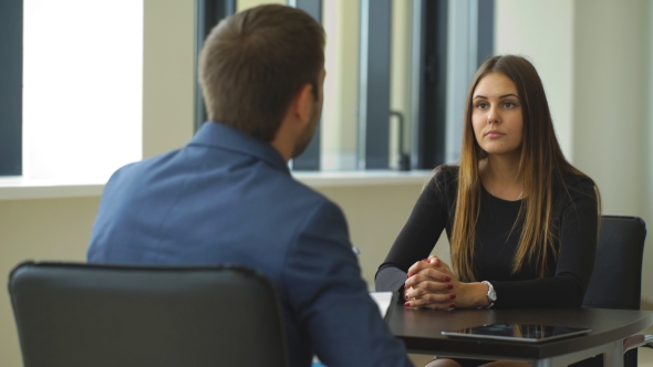 a Woman Answers Questions Of The Employer At The Interview