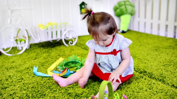 A Baby Playing By His Crib In His Room