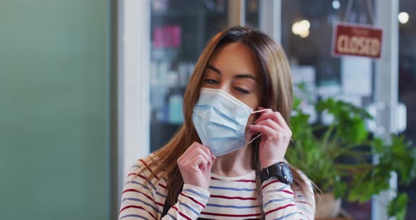 Portrait of Female hairdresser wearing face mask at hair salon