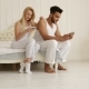 Couple Using Smart Phone Sitting Bed Mix Race Man Woman Embrace Smile Morning Bedroom - VideoHive Item for Sale