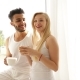 Couple Drink Coffee Morning Sitting Near Window Mix Race Man Woman Smile - VideoHive Item for Sale