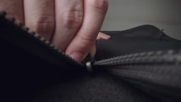 Extreme Close Up Zipper with Hand Unzipping the Sweater Jacket Zipper