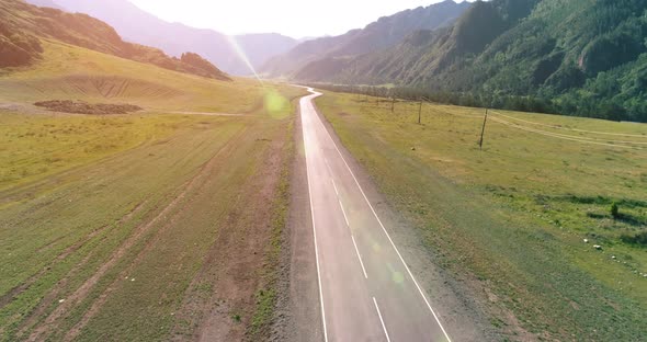 Flight Over Mountain Asphalt Highway Road and Meadow