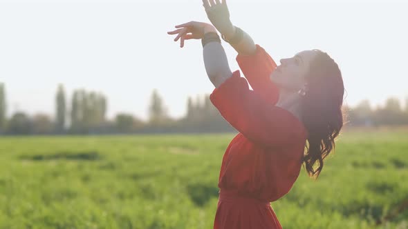 Beautiful Spanish Brunette Woman in Red Dress Dancing at Sunset in Wheat Field Slow Motion Shot