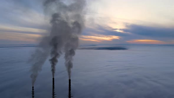 Coal Power Plant High Pipes with Black Smoke Moving Upwards Polluting Atmosphere