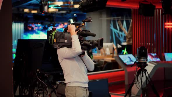 Cameraman Working In TV Studio Video Production Filming Interview. Television Operator On TV Channel