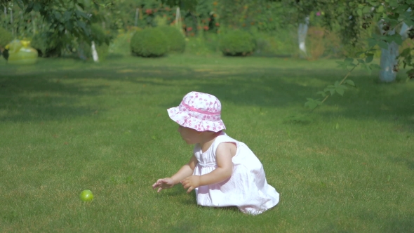 Baby Crawling on the Grass to the Apple.